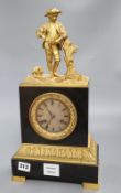 A 19th century French ormolu mounted black marble eight day mantel clock, surmounted by a figure