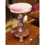 A Victorian rosewood pink upholstered revolving piano stool