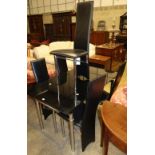 A modern chrome and black glass extending dining table with six matching dining chairs