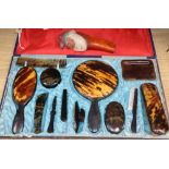 A cased tortoiseshell dressing table set and a gnome nut cracker