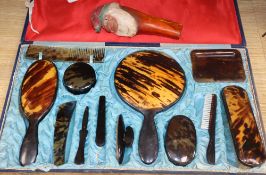 A cased tortoiseshell dressing table set and a gnome nut cracker