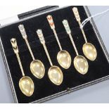 A cased set of six silver gilt and enamel coffee spoons