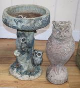 A reconstituted stone garden ornament of an owl, H.38cm, together with a plastic bird bath