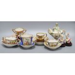 Four gilt decorated cabinet cups and saucers, a floral encrusted pot, height 15cm and two busts on