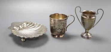 A Victorian silver christening can "Marie", a George V scallop shell dish and a small trophy cup,