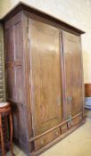 An 18th century Normandy oak two door armoire with brass escutcheons and buttressed hinges, W.178cm,