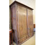 An 18th century Normandy oak two door armoire with brass escutcheons and buttressed hinges, W.178cm,