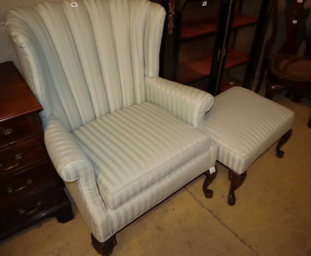 A Queen Anne I style wing armchair on shell carved cabriole forelegs, W.83cm, H.101cm and a matching