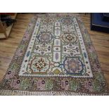 A Caucasian design ivory ground rug, 320 x 195cmCONDITION: One cigar burn and one small patch of