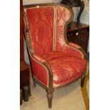 A late 19th century mahogany wing armchair with foliate and scroll carved frame, W.80cm, H.112cm