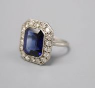 A platinum synthetic sapphire and diamond octagonal cluster ring, size O