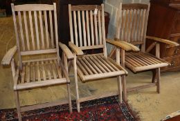 Three teak folding garden armchairs