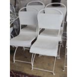 A set of four painted metal garden chairs