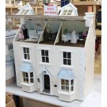 A modern Victorian style dolls house with antique and other furniture and contents including