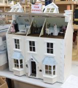 A modern Victorian style dolls house with antique and other furniture and contents including