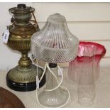 A brass oil lamp with shade and chimney, height 38cm and a glass table lamp