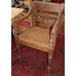 A set of six Anglo Indian teak cane seat elbow chairs