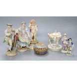 A pair of Meissen figures, a Meissen putti, two smaller Meissen figures, a lidded centrepiece and an