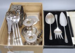A pair of silver plated candlesticks, a coaster, box cutlery etc