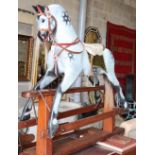 A mid 20th century Collinson dapple grey rocking horse on pine safety frame (restored by Stevenson