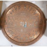 A large circular copper tray with white metal inlay depicting ancient Egyptian scenes, diameter