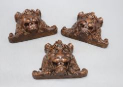 Three French carved walnut lion's masks, width 17cm