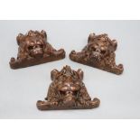 Three French carved walnut lion's masks, width 17cm