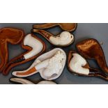 Four various Meerschaum pipes, in fitted case