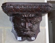 A late Victorian carved oak wall bracket, W.46cm, H.34cm