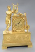 A French Empire design ormolu eight day mantel clock, the case surmounted with a Grecian figure