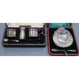 A silver cruet set and a silver shell-shaped butter dish and knife (both cased)