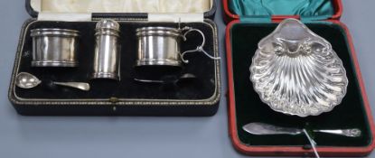 A silver cruet set and a silver shell-shaped butter dish and knife (both cased)