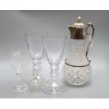 A pair of wine glasses, a similar etched wine glass and a cut glass claret jug, height 30cm