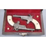 A cased pair of pin-fire muff pistols, late 19th/early 20th century, each barrel crudely stamped LC,