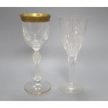 A set of seven gilt rimmed wine glasses and eight glass flutes