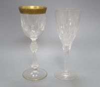 A set of seven gilt rimmed wine glasses and eight glass flutes