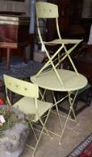 A folding painted circular garden table, 69cm diameter and pair of folding chairs