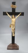 A carved ivory and ebony crucifix, height 59cmCONDITION: There are some age splits to the ebony