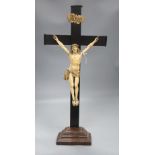 A carved ivory and ebony crucifix, height 59cmCONDITION: There are some age splits to the ebony