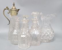 Four glass decanters, a claret jug and another jug, tallest 34cm