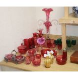 A Victorian cranberry glass epergne, height 56cm, a set of green glasses, two vaseline vases, etc