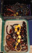 A cherry amber bead necklace and glass bead necklaces in two jewellery boxes