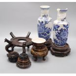 A pair of Chinese blue and white vases, a teabowl and a collection of wooden stands
