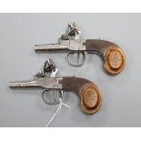 A pair of Continental flintlock pocket pistols, with silver wire inlaid walnut grips turn off