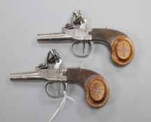 A pair of Continental flintlock pocket pistols, with silver wire inlaid walnut grips turn off