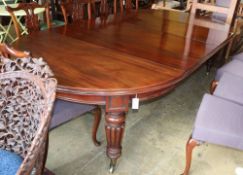 A Victorian mahogany extending dining table by Edwards and Roberts, together with an oak table