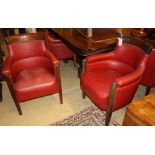 A set of six mahogany framed tub shaped theatre viewing armchairs, with red leather upholstery (by