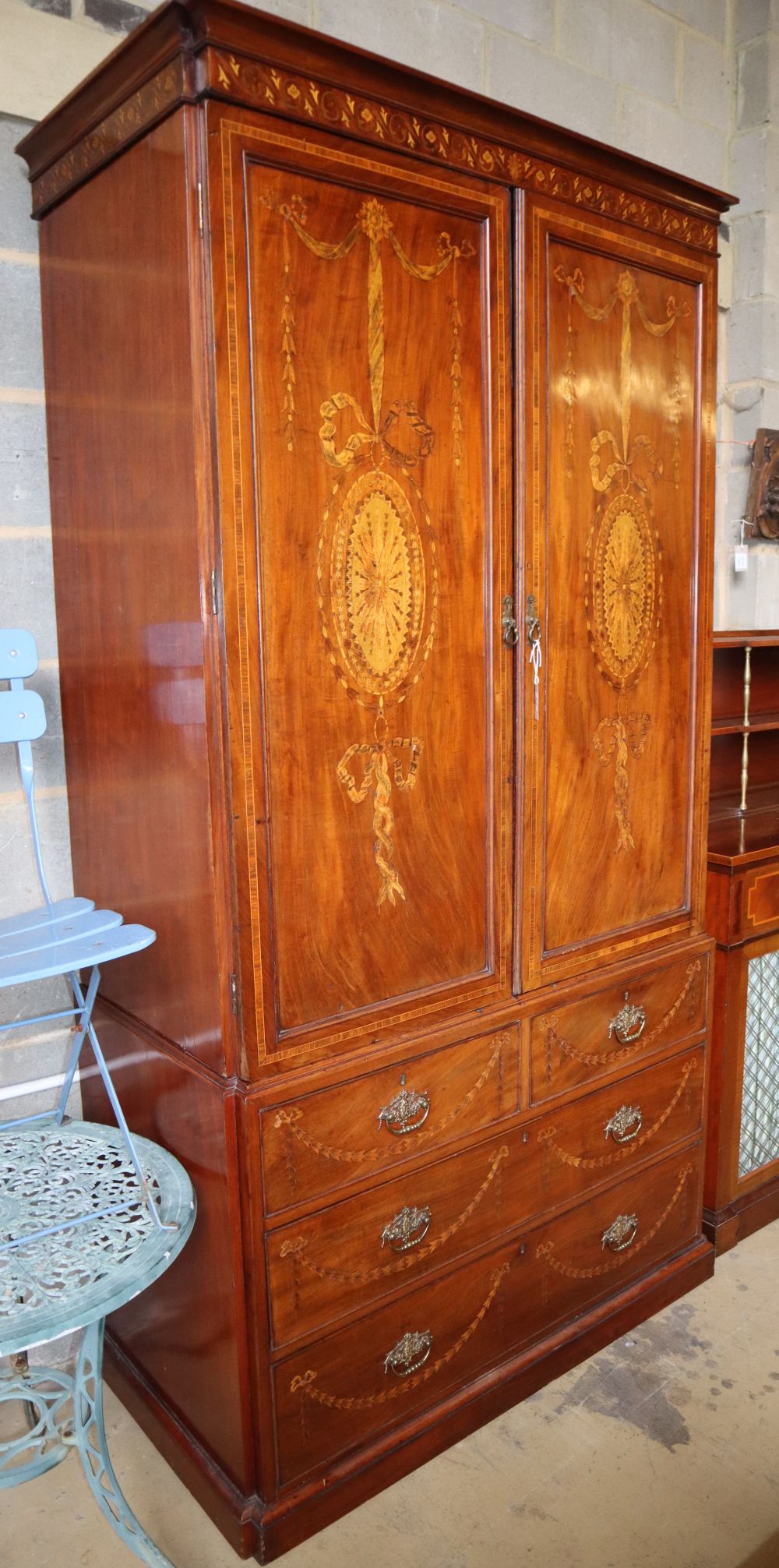 An Edwardian Sheraton revival marquetry inlaid mahogany linen press, W.116cm, D.58cm, H.223cm