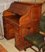 An early 20th century oak roll top desk with 'S' shaped tambour, W.106cm, D.76cm, H.125cm