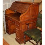 An early 20th century oak roll top desk with 'S' shaped tambour, W.106cm, D.76cm, H.125cm